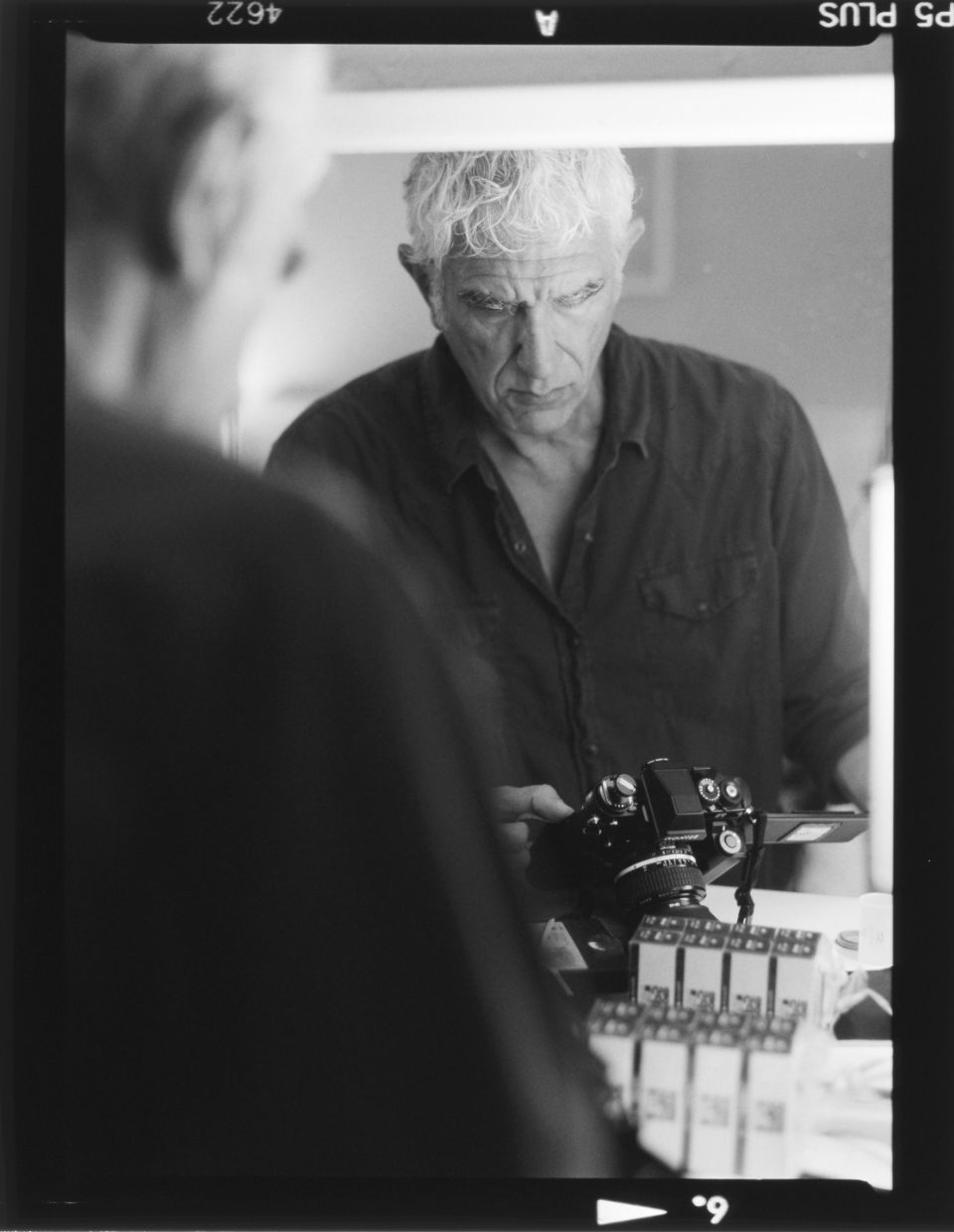 Luigi Cassinelli self-portrait loading Nikon F3 with film